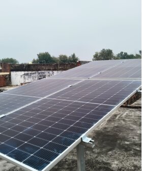 Modern home with rooftop solar panels in bright sunlight